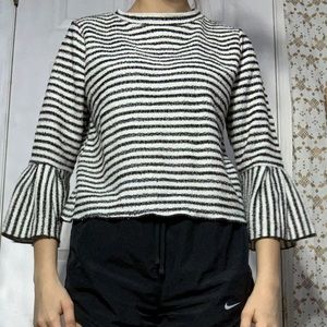 A striped white and black long sleeve top